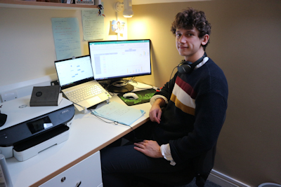 picture of student Theo Holland at a desk